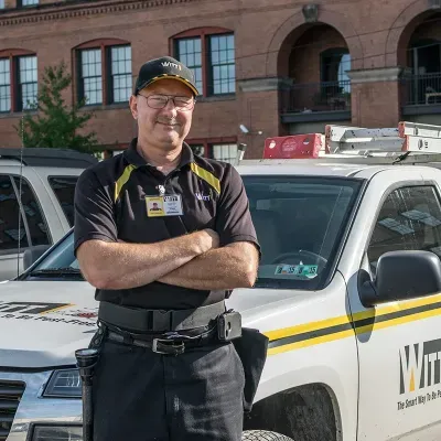 Technician standing in front of company truck