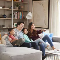 Family sitting on couch in living room