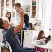 family in gathered in kitchen