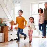 family coming in the front door of the house