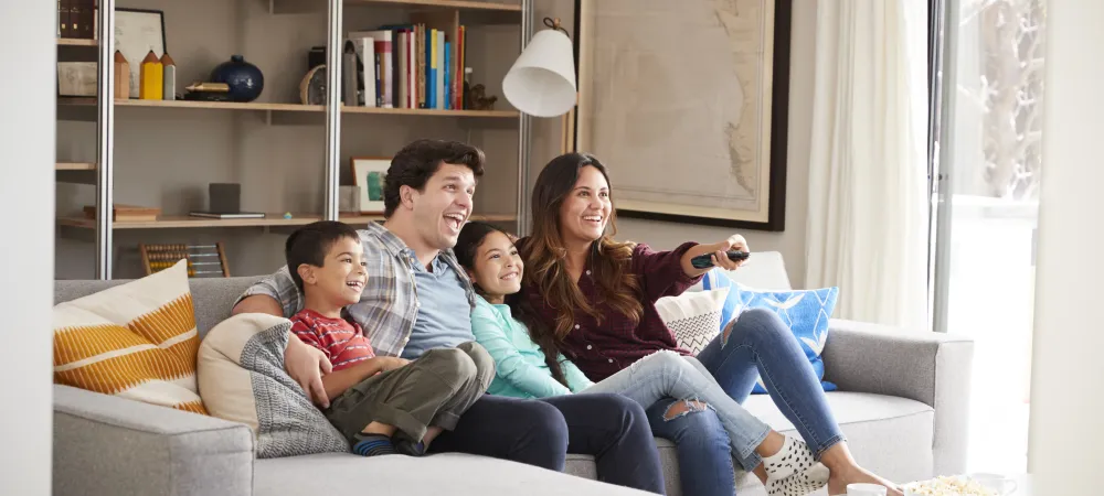 Family sitting on couch in living room