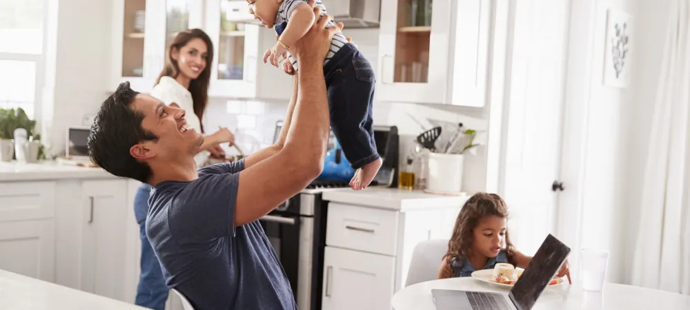 family in gathered in kitchen