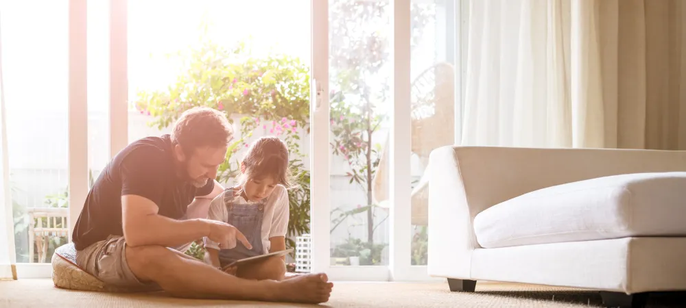 father and daughter looking at tablet