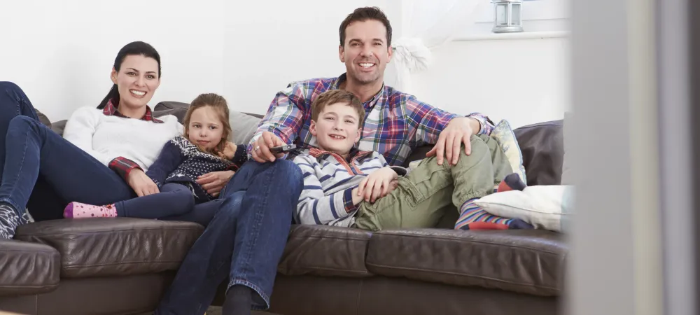 Family of four sitting on the couch