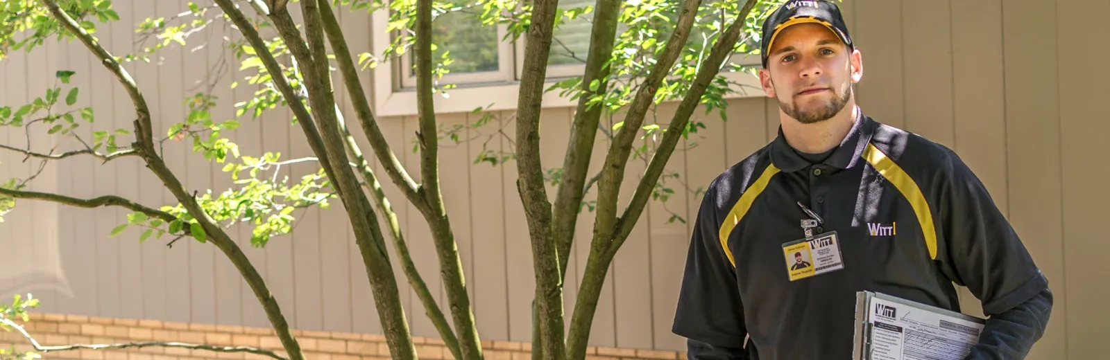 technician standing in front of house
