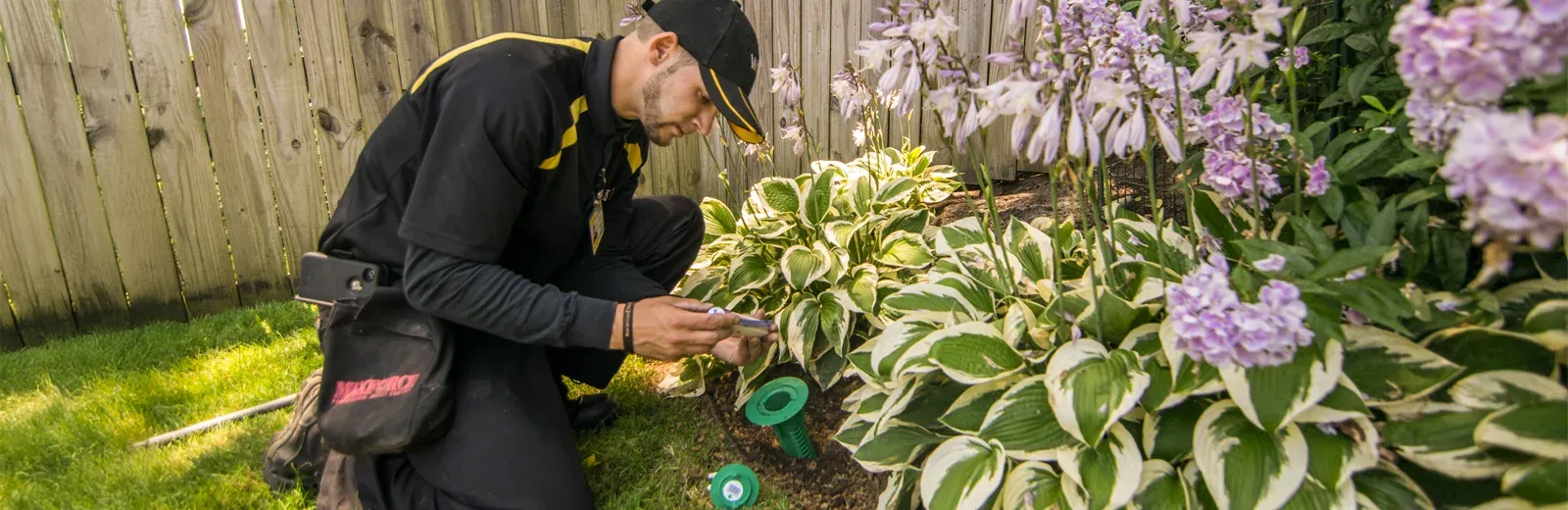 technician checking termite bait station